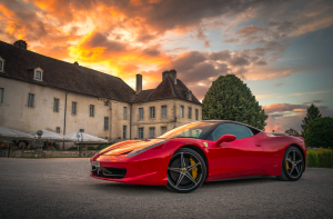 sports car in front of mansion